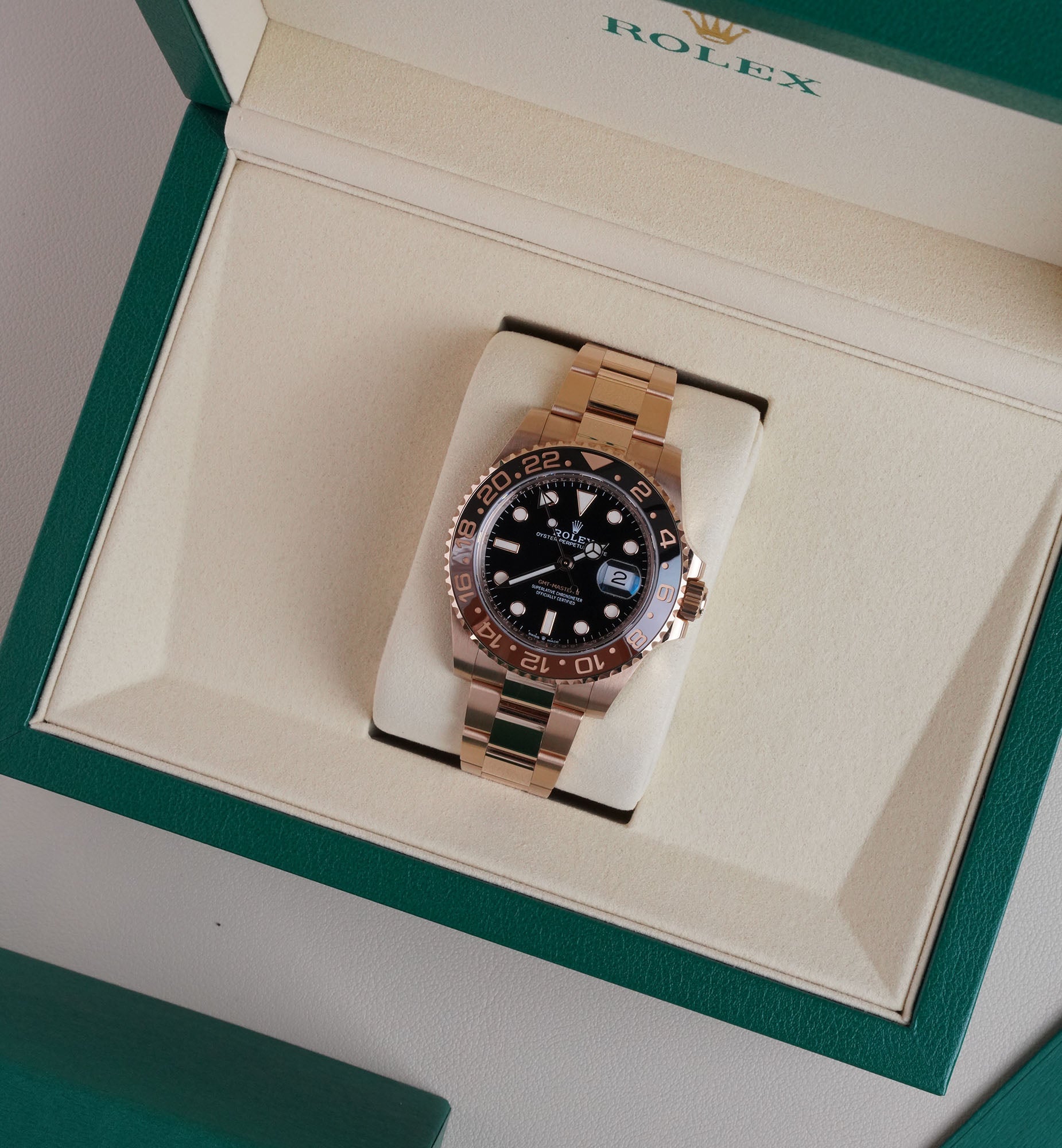 Rolex GMT-Master II Root Beer in Everose gold with black and brown ceramic bezel displayed in original Rolex box available at Konesseur Dubai